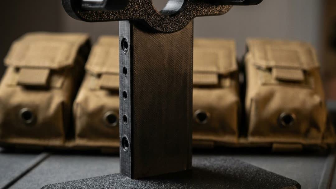 Airsoft pistol displayed on black 3D printed stand